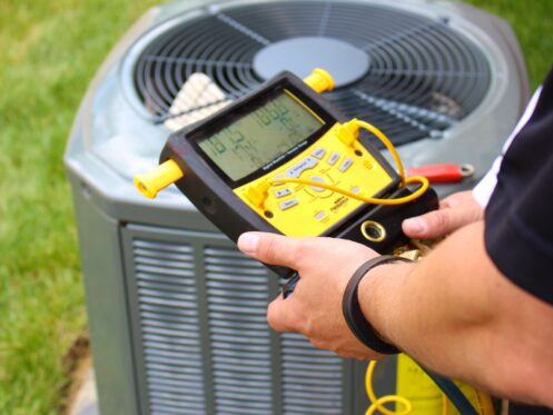 An AC tech running a check on an AC in Hillsboro, OR